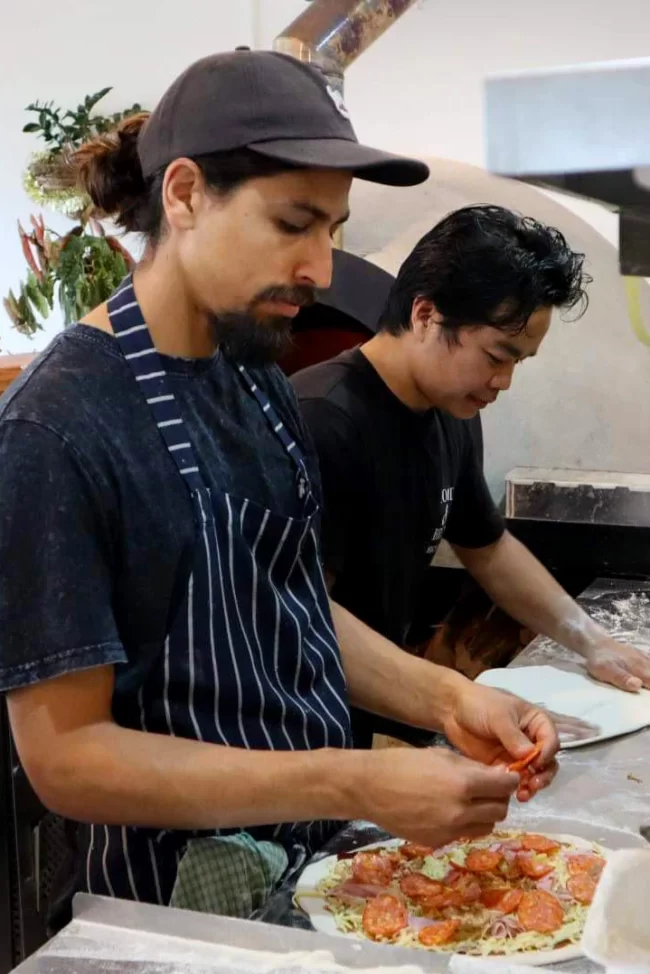 cooks in the kitchen preparing delicious food for Food n Brew
