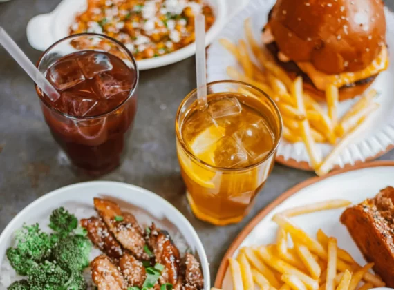 top view of a table with plates of food and drinks